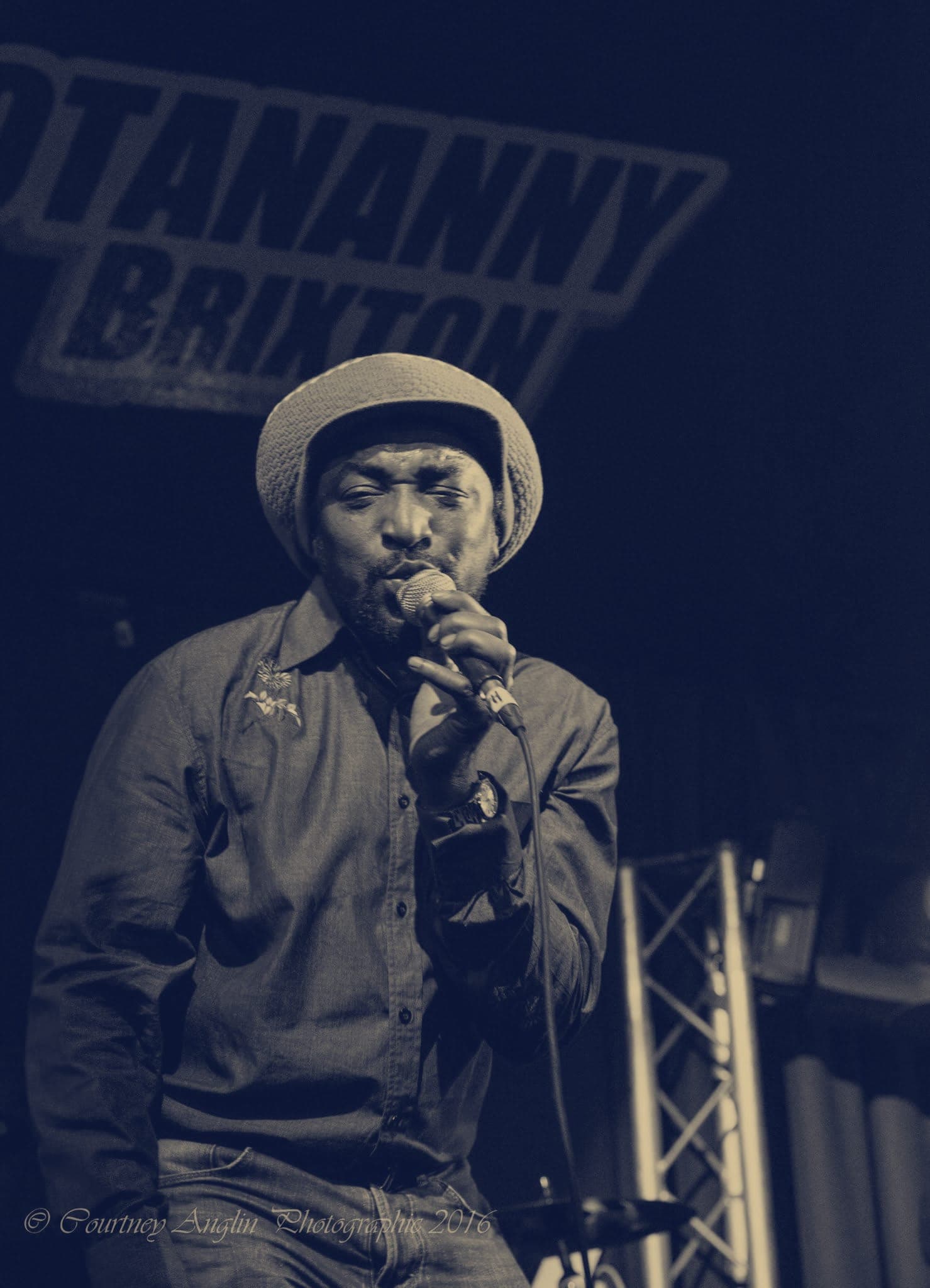 Kareem Shabazz holding the microphone close under blue light at Hootananny Brixton